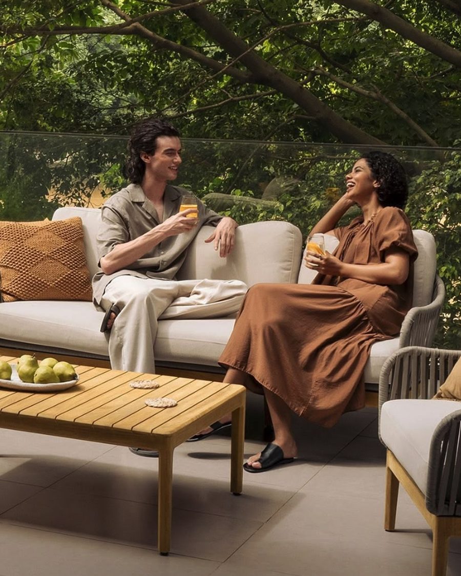 A young couple relaxing together on the balcony of their home